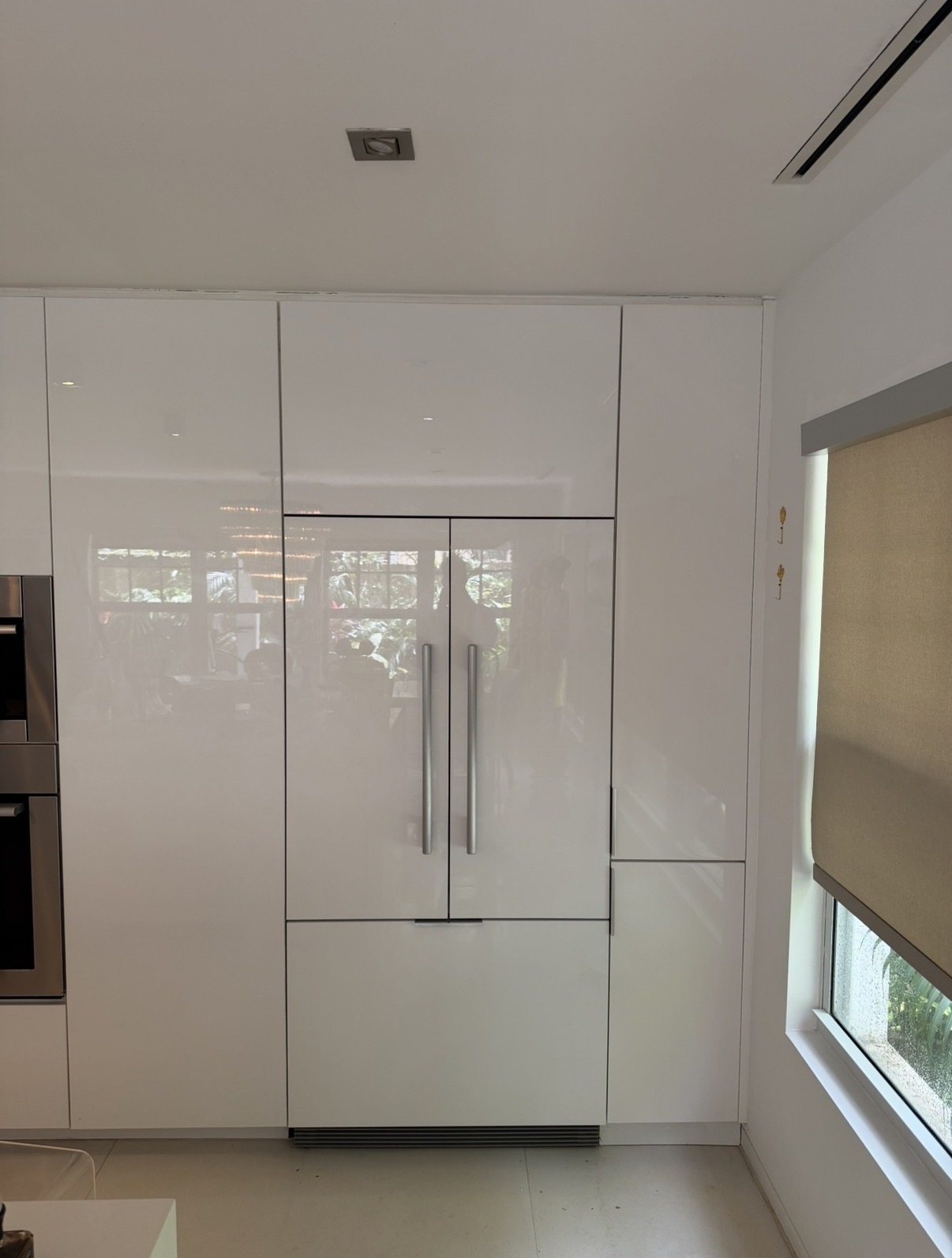 Fisher & Paykel built-in refrigerator integrated into white kitchen cabinetry