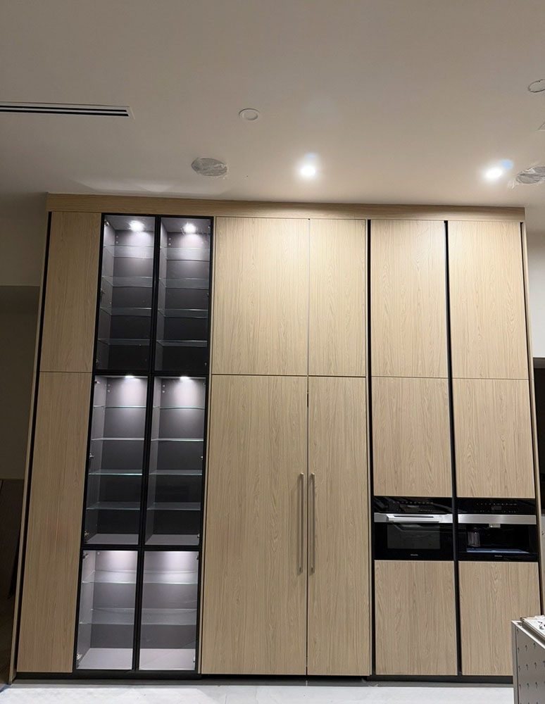 Premium wood kitchen with Miele built-in appliances and lighted cabinetry