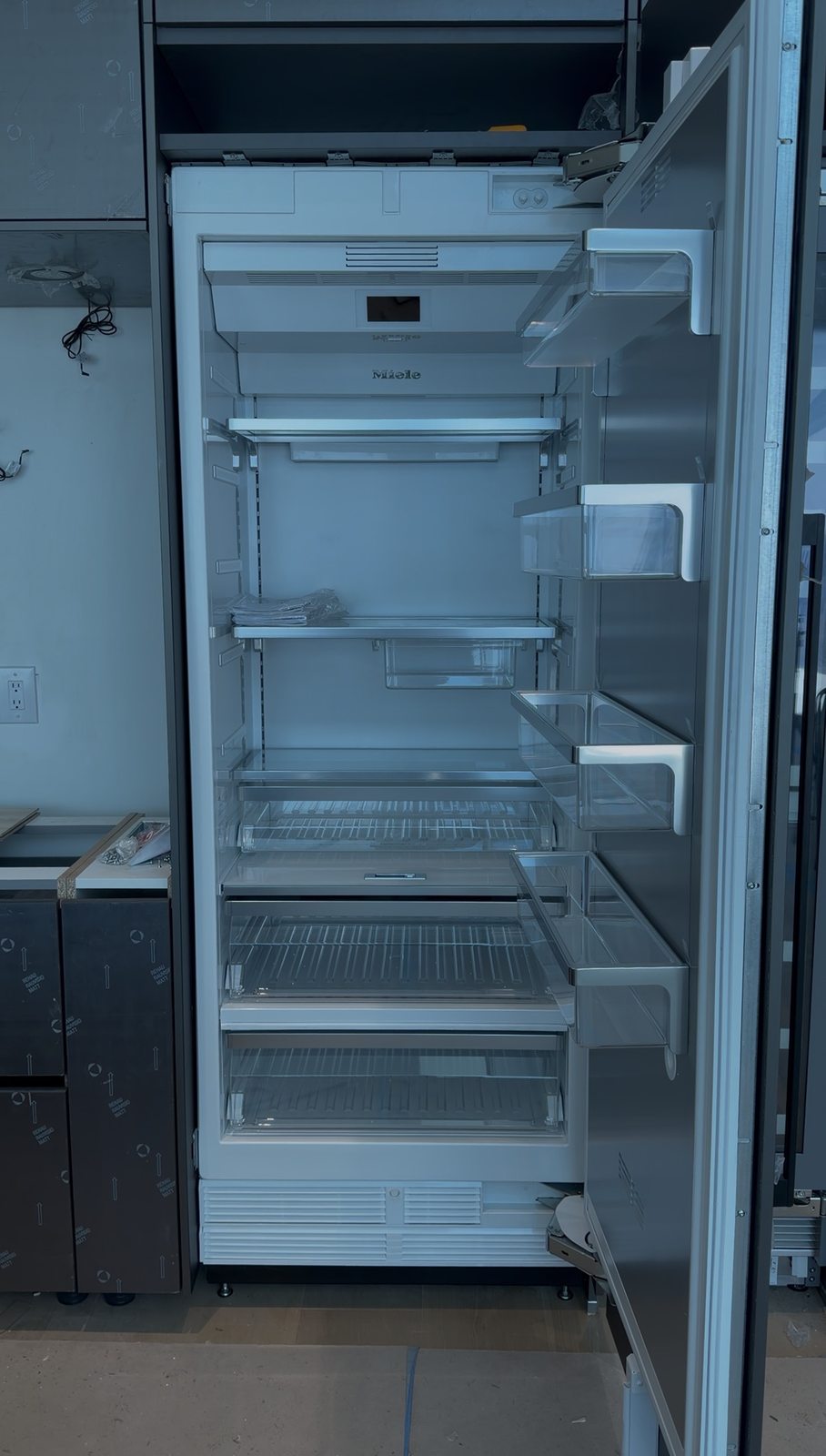 Open Miele built-in refrigerator interior