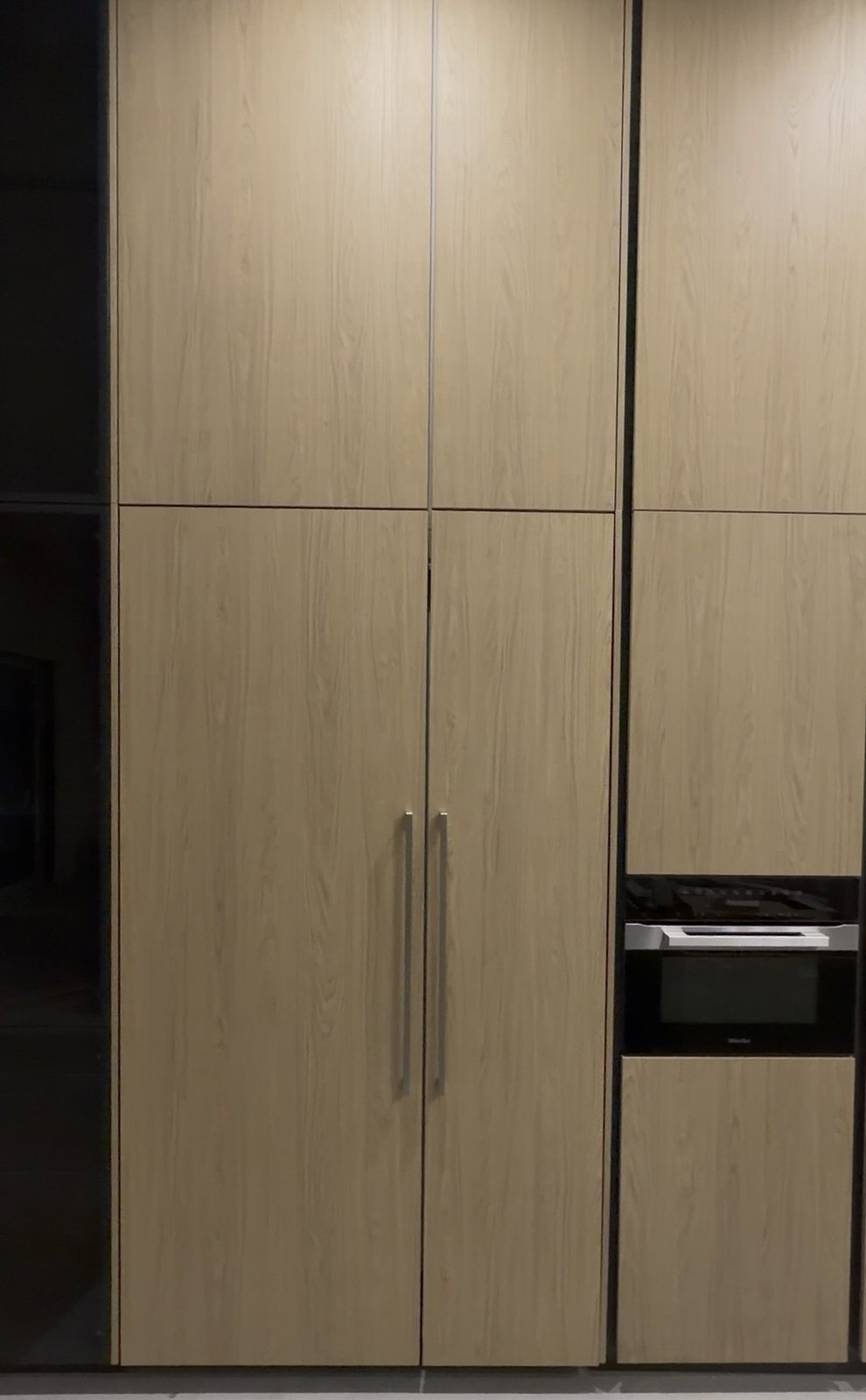Closed panel-ready refrigerator with custom wood cabinet panels