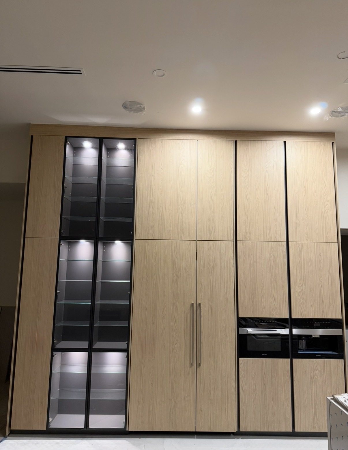 Premium wood kitchen with Miele built-in appliances and lighted cabinetry